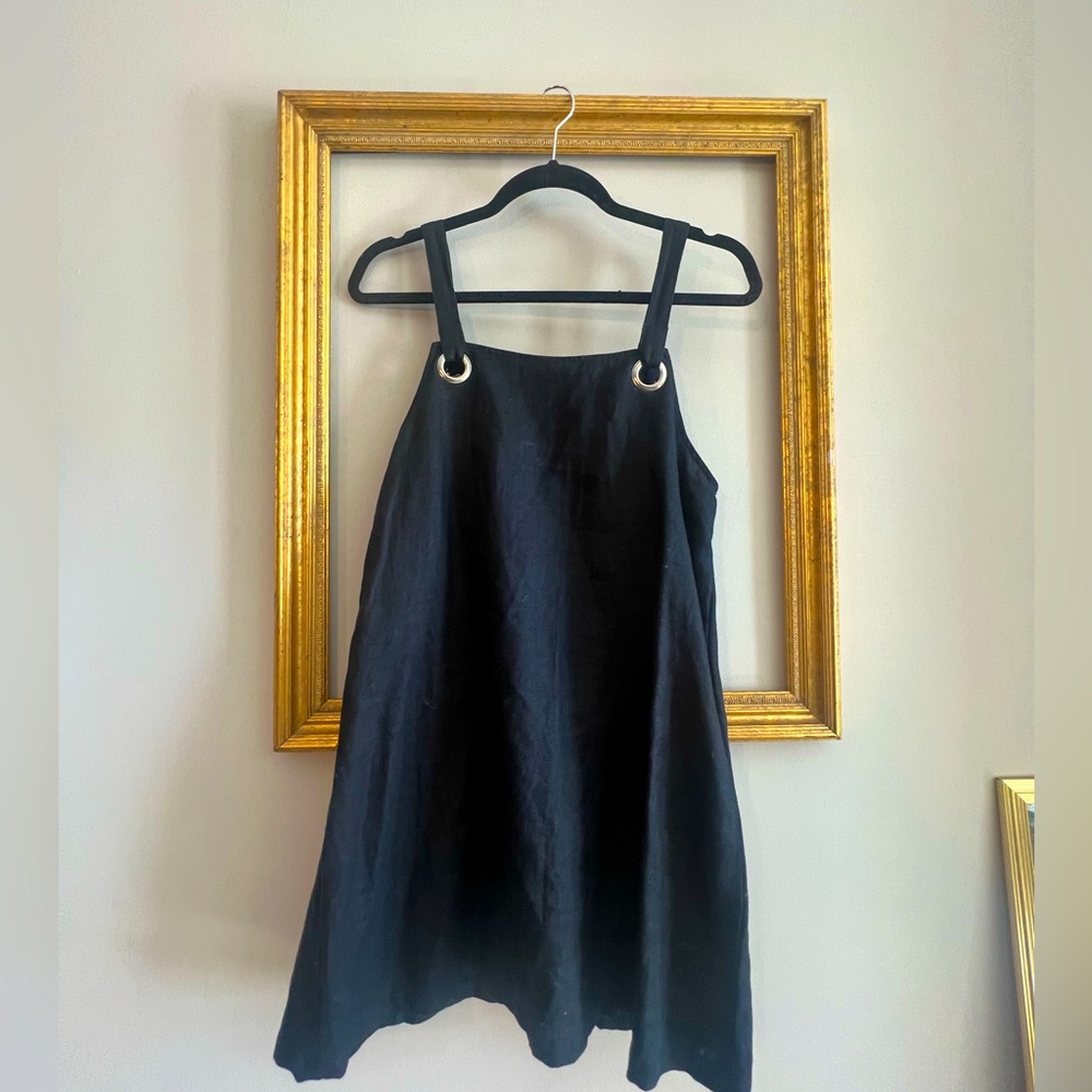 Vintage overall black dress. No signs of wear. Comes to mid thigh.